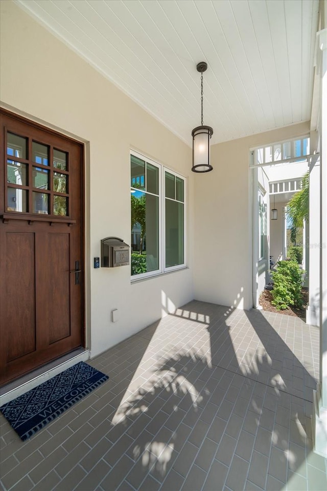 view of exterior entry with a porch