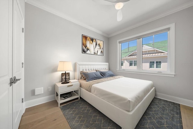 bedroom featuring ceiling fan, dark hardwood / wood-style flooring, and ornamental molding