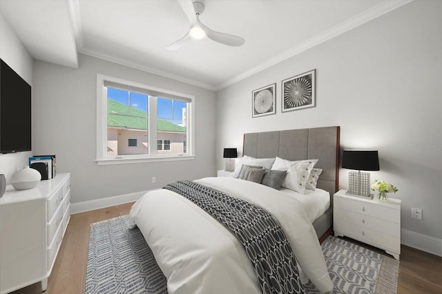 bedroom with hardwood / wood-style flooring, ceiling fan, and ornamental molding