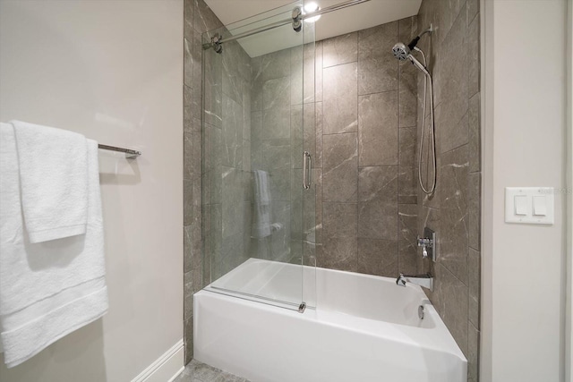 bathroom featuring combined bath / shower with glass door