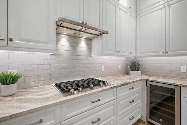 kitchen with white cabinets, tasteful backsplash, wine cooler, and stainless steel gas stovetop