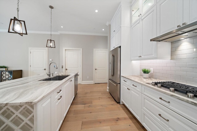 kitchen featuring sink, white cabinets, and light wood-type flooring