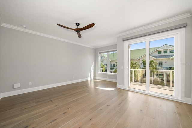 empty room featuring light wood-type flooring, plenty of natural light, crown molding, and ceiling fan