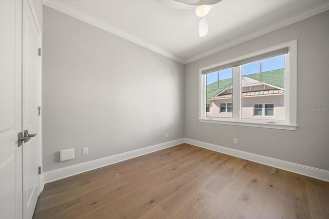 empty room with hardwood / wood-style flooring, ceiling fan, and ornamental molding