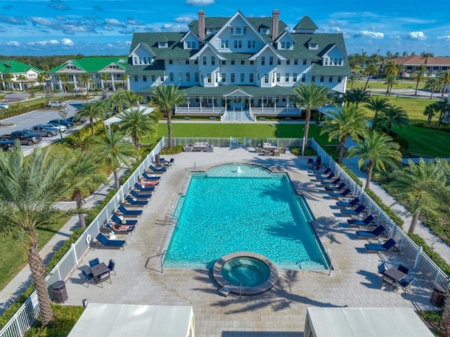 view of pool featuring a patio and a hot tub