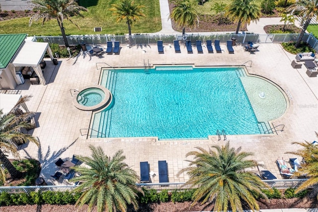 view of swimming pool with a patio and a hot tub