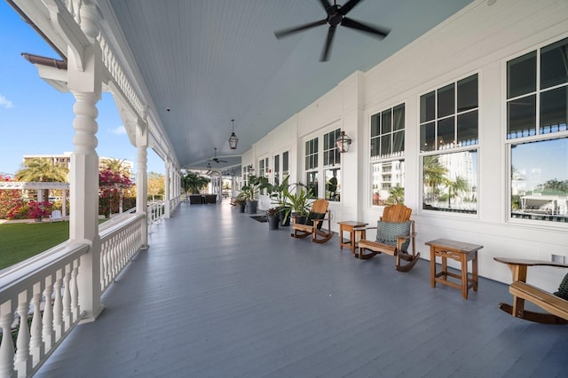 sunroom with ceiling fan and lofted ceiling