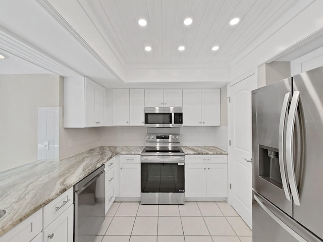 kitchen with white cabinetry, light tile patterned floors, stainless steel appliances, and light stone counters