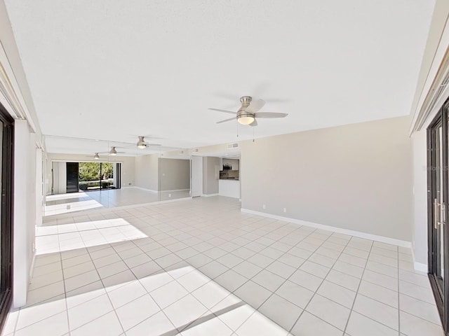 unfurnished living room featuring ceiling fan and light tile patterned flooring