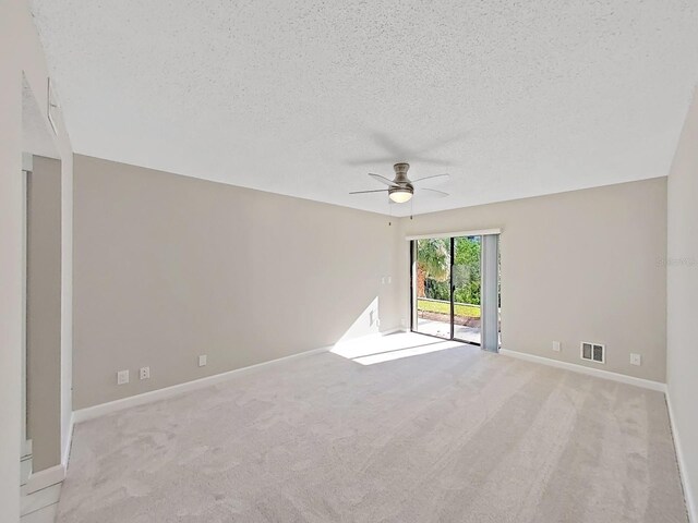 unfurnished room with light carpet, a textured ceiling, and ceiling fan