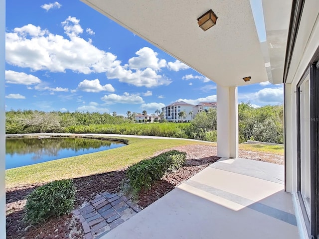 view of patio with a water view