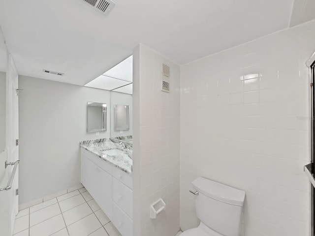 bathroom featuring tile patterned flooring, vanity, and toilet