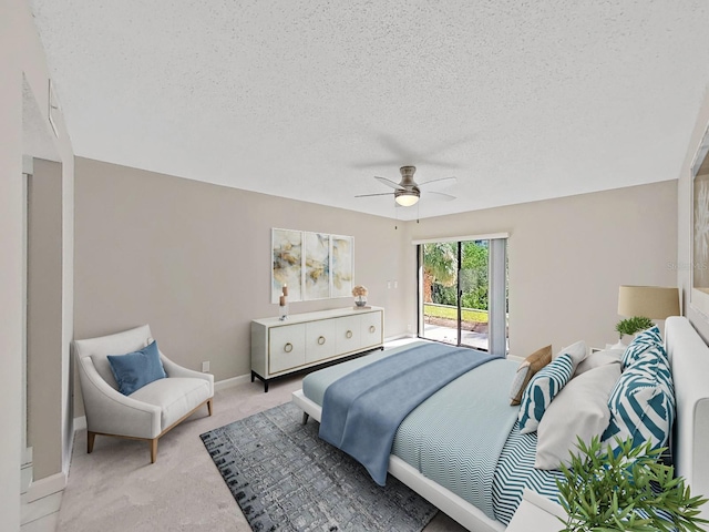 carpeted bedroom featuring ceiling fan, a textured ceiling, and access to outside