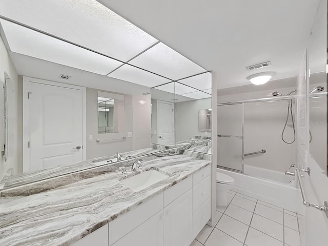 full bathroom with tile patterned floors, toilet, vanity, and combined bath / shower with glass door