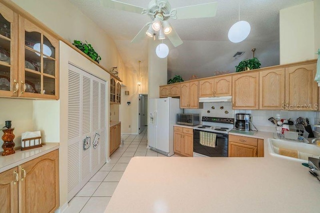 kitchen with decorative backsplash, white appliances, sink, lofted ceiling, and light tile patterned flooring