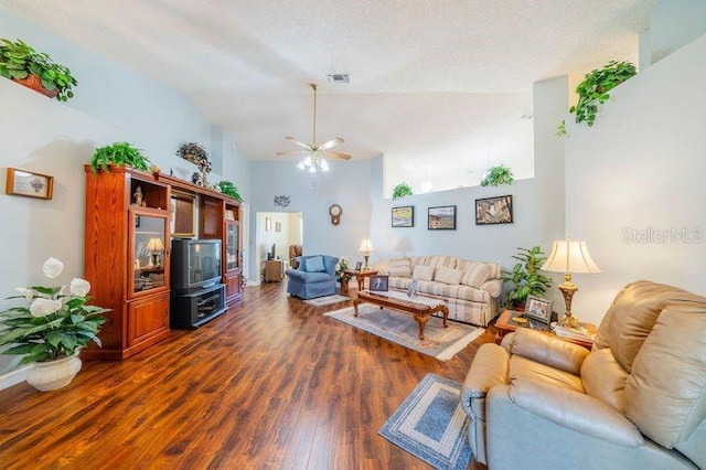 living room featuring a textured ceiling, dark hardwood / wood-style floors, vaulted ceiling, and ceiling fan