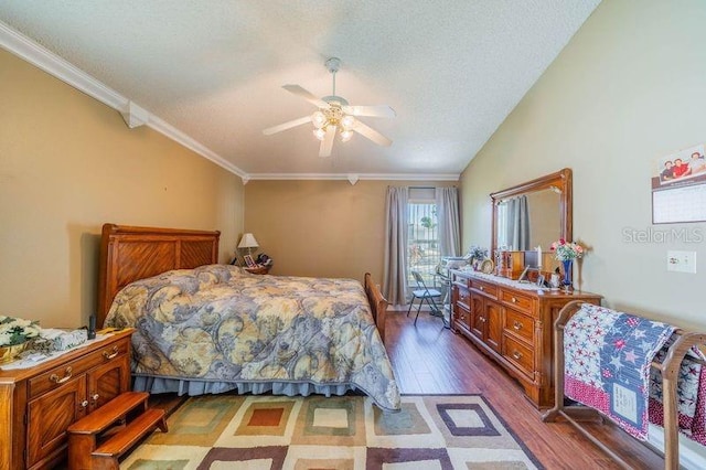 bedroom with vaulted ceiling, crown molding, ceiling fan, and dark wood-type flooring