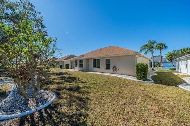 rear view of property with a yard