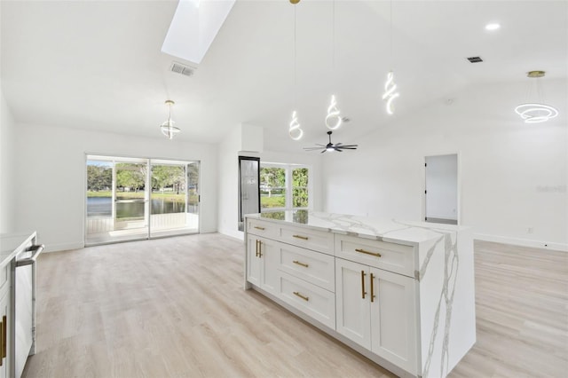 kitchen featuring a wealth of natural light and pendant lighting