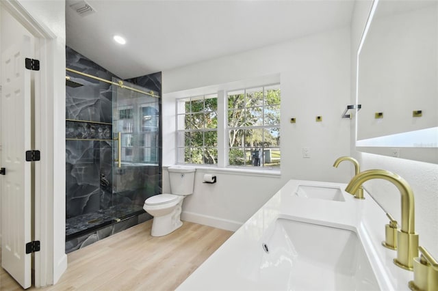 bathroom featuring vanity, wood-type flooring, lofted ceiling, and walk in shower