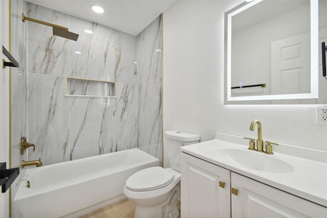 full bathroom featuring vanity, tiled shower / bath combo, and toilet