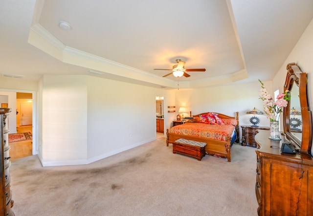 bedroom with a tray ceiling, ceiling fan, ornamental molding, and light colored carpet