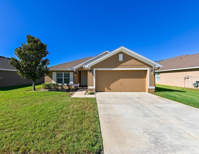 single story home featuring a garage and a front lawn