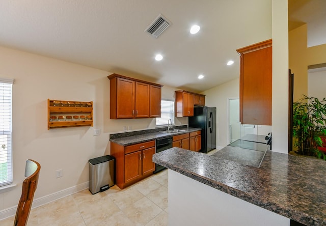 kitchen with kitchen peninsula, sink, plenty of natural light, and black appliances