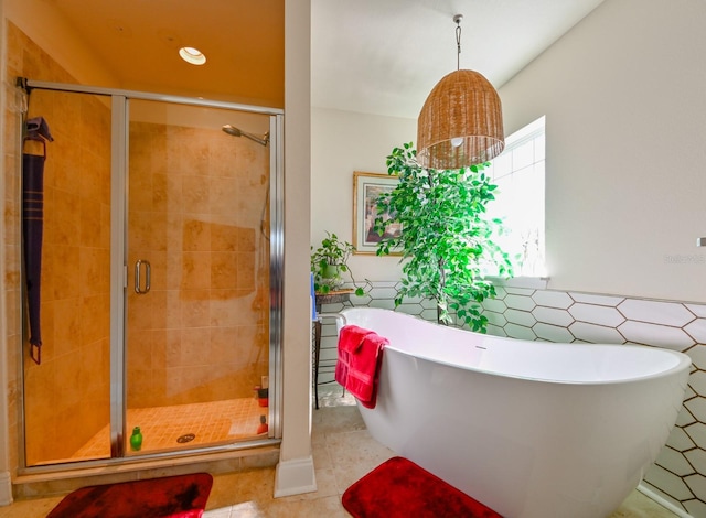 bathroom featuring tile patterned flooring and separate shower and tub