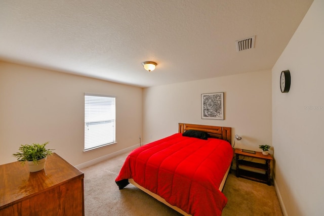 bedroom with carpet and a textured ceiling