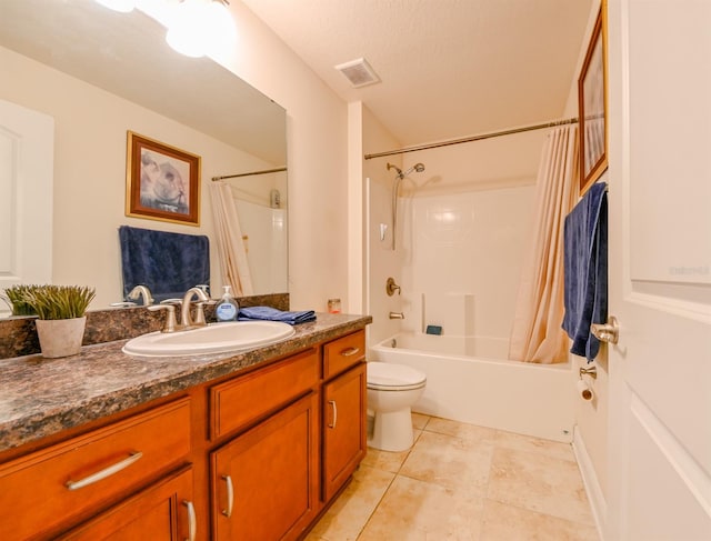 full bathroom featuring tile patterned floors, a textured ceiling, toilet, vanity, and shower / tub combo