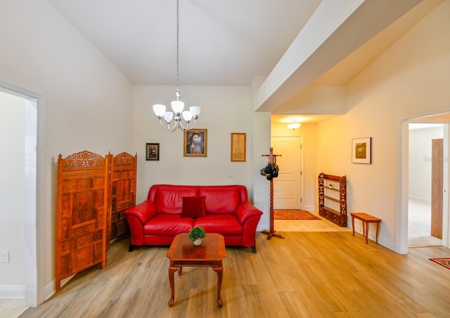 living room with hardwood / wood-style floors and a notable chandelier