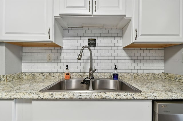 kitchen featuring backsplash, white cabinetry, and sink