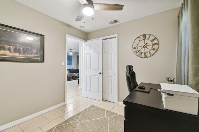 tiled office space featuring ceiling fan