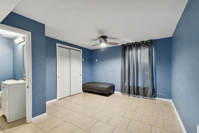 bedroom featuring ceiling fan, light tile patterned flooring, and a closet