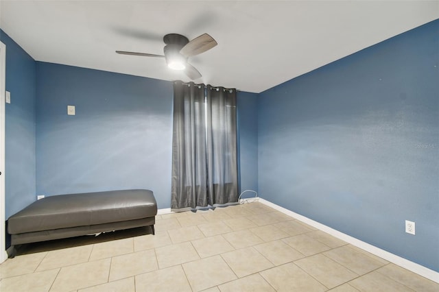 unfurnished room featuring ceiling fan and light tile patterned floors