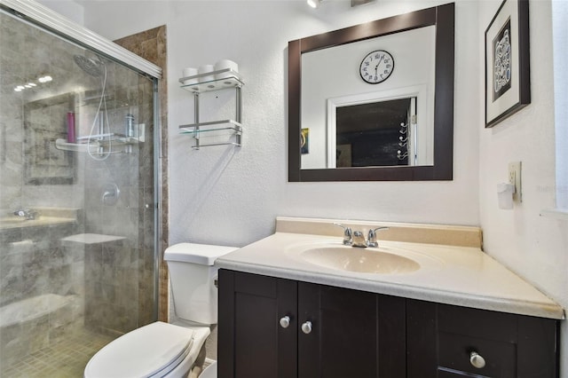 bathroom featuring a shower with door, vanity, and toilet