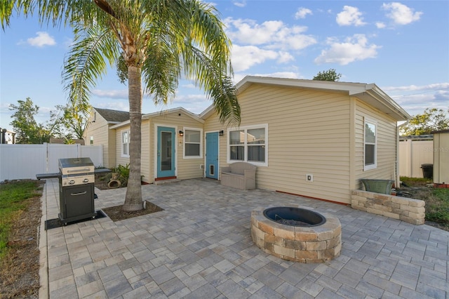 back of house featuring a patio and a fire pit