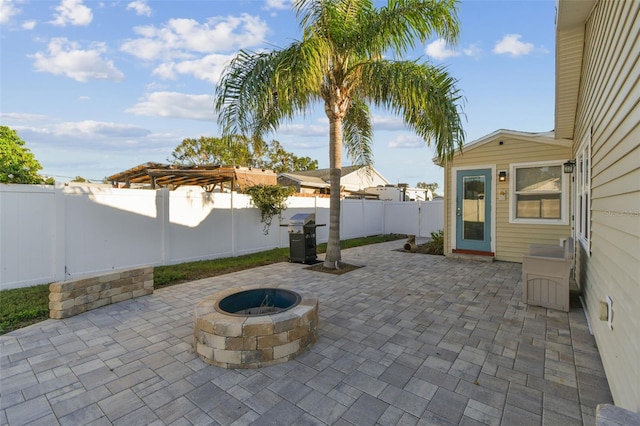 view of patio / terrace featuring grilling area and a fire pit