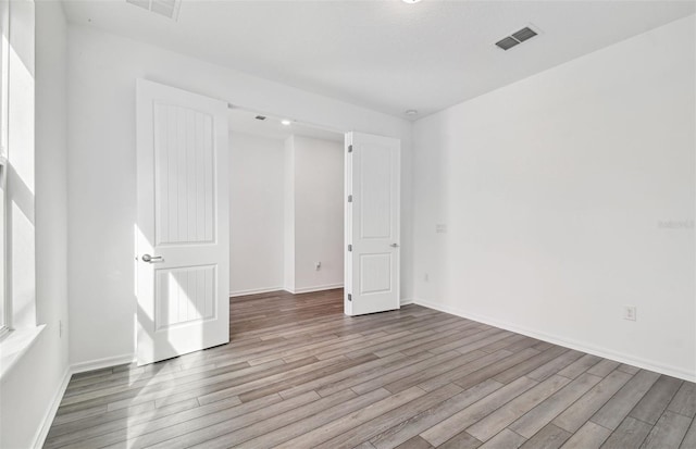 spare room with light wood-type flooring