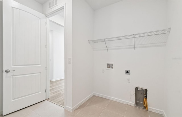 laundry area featuring hookup for an electric dryer, washer hookup, and light tile patterned floors