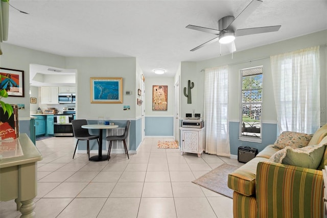 tiled living room featuring ceiling fan