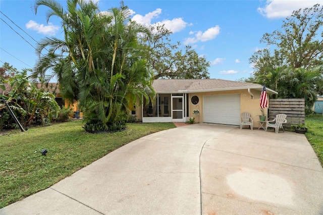 view of front of property featuring a garage, a sunroom, and a front yard