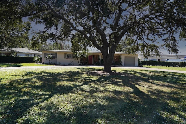 single story home featuring a front yard and a garage