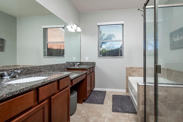 bathroom featuring tile patterned flooring, shower with separate bathtub, vanity, and a textured ceiling