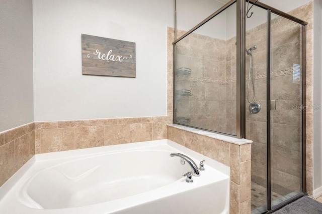 bathroom featuring independent shower and bath