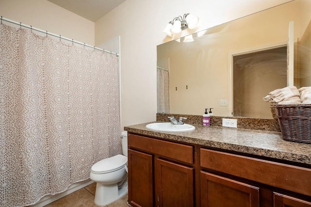 bathroom featuring tile patterned flooring, vanity, and toilet