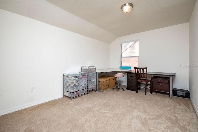 office area featuring light carpet and vaulted ceiling