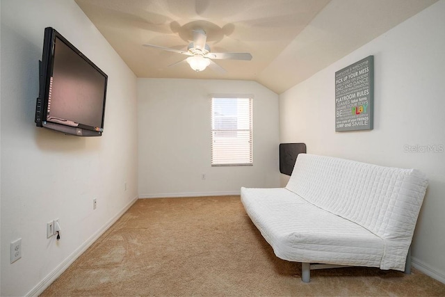 sitting room with light colored carpet, vaulted ceiling, and ceiling fan