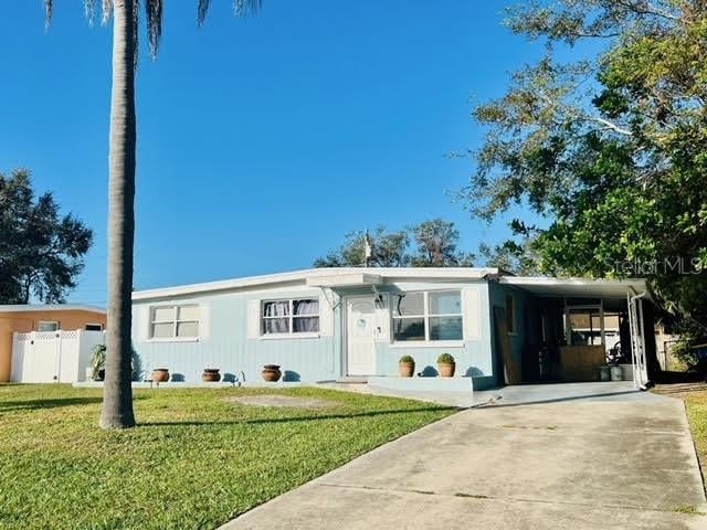 view of front of house with a front yard and a carport